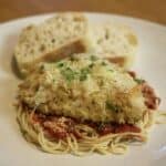 sous vide parmesan chicken on top of spaghetti