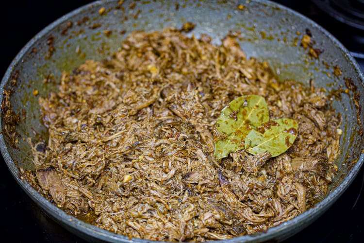 sous vide shredded beef in barbacoa sauce in pan