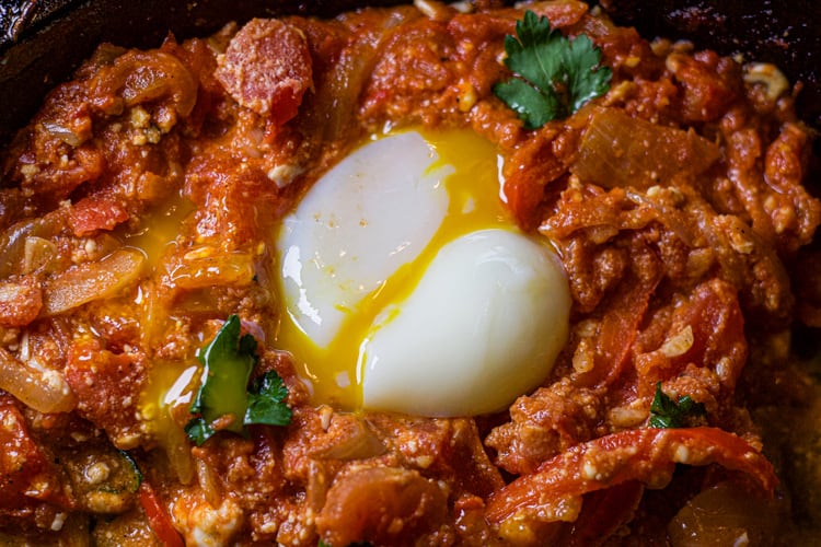 perfect sous vide poached egg in a bed of shakshuka