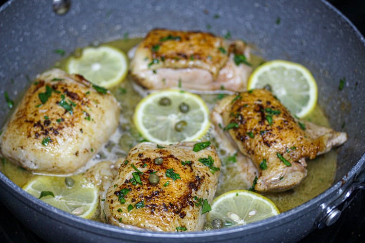 Sous vide chicken thigh piccata in pan seared with lemons and capers