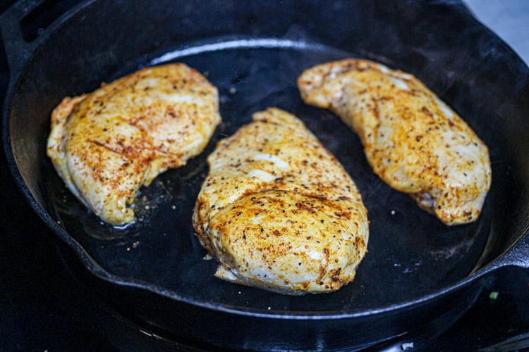 sous vide chicken breast searing on cast iron
