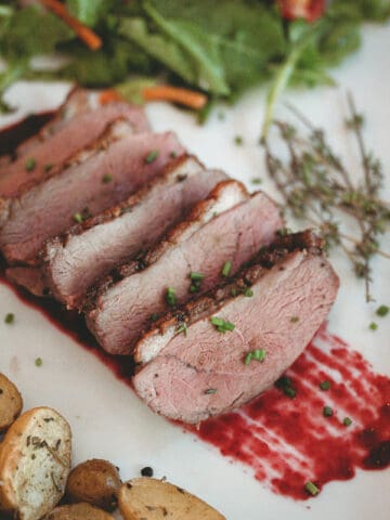 sous vide duck breast sliced with blackberry sauce