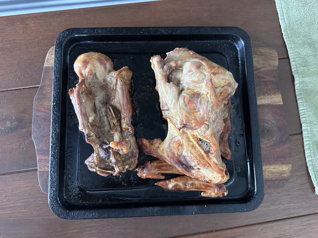 Roasted turkey backbone and bones on a tray, ready for stock