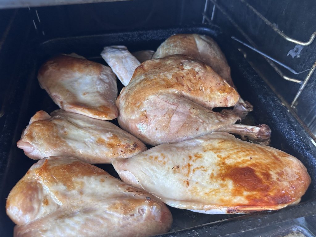 Sous vide turkey legs and breasts browning in a hot oven