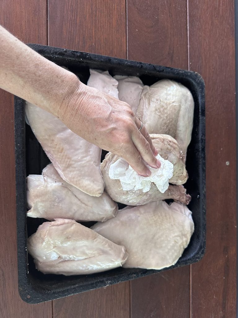 Patting sous vide turkey pieces dry with paper towel before finishing in the oven
